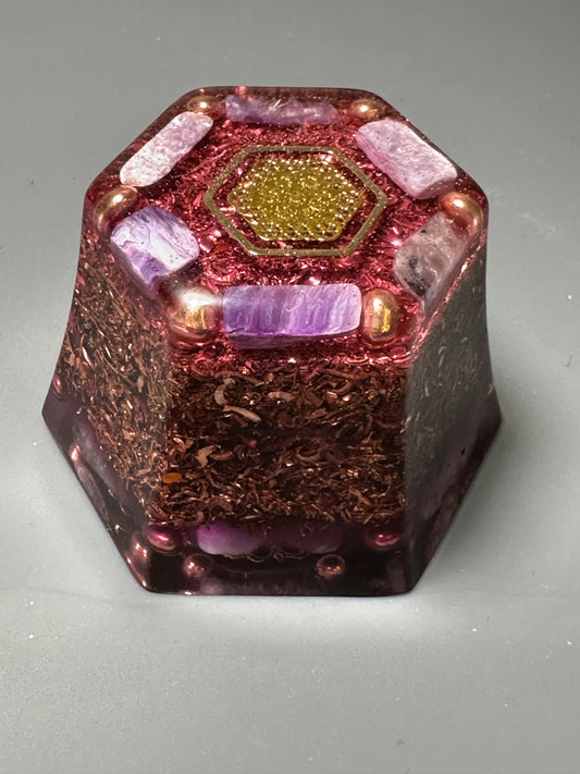 A hexagon shape orgonite is loaded with copper shavings